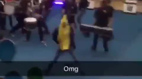 Guy dressed in banana costume runs through pep rally