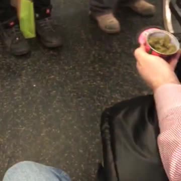 Guy takes a picture of his weed in a can on subway train