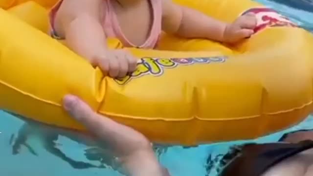 Cute baby dancing in the pool