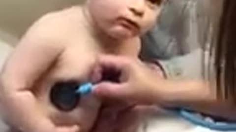 Cute Baby Boy Rests Head On Nurse's Hand .