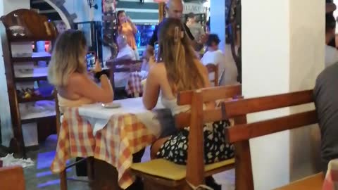 Greek waiters dancing with glass on their head