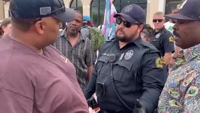 Dallas Man walk down the street past the woke Brigade