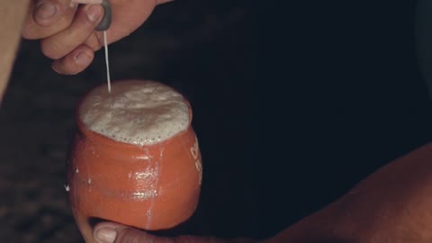 close-up-footage-of-a-person-milking-a-cow