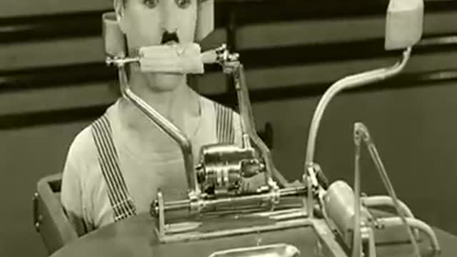 Charles chaplin with feeding machine