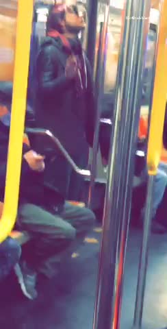 Guy flails hand on subway train