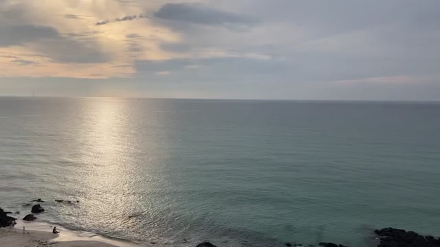 Wide beach of Jeju Island at sunset