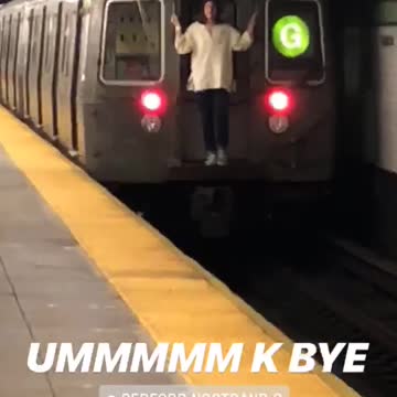 Guy white long riding behind moving subway train