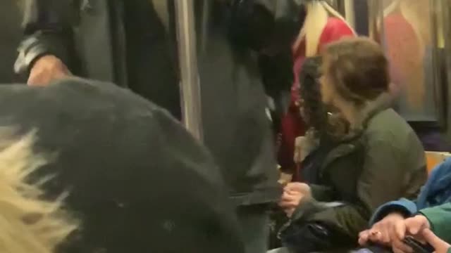 Three men sing gospel music on subway train