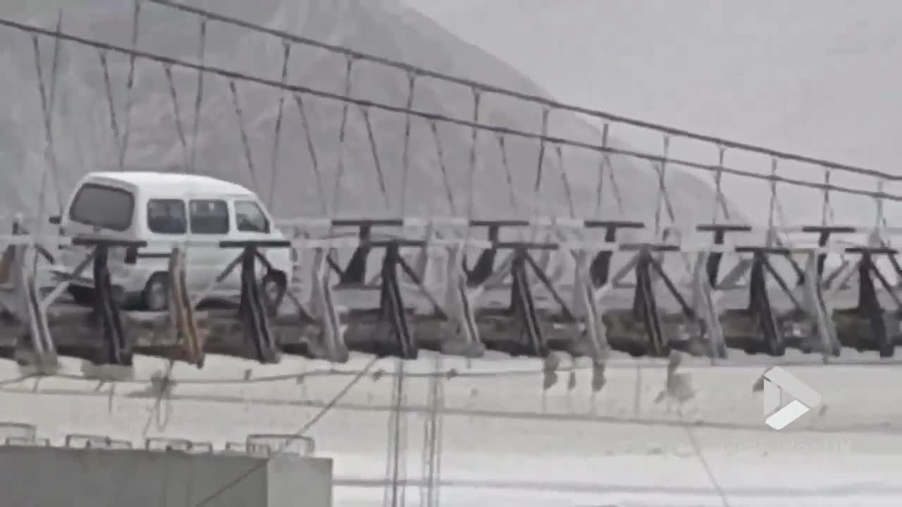 Car on scary suspension bridge