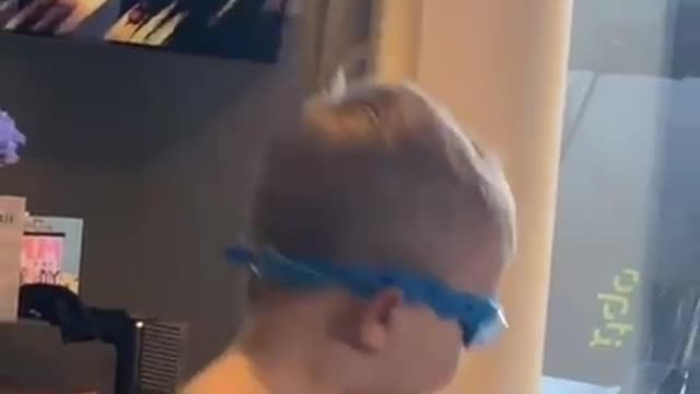 Kid runs through glass door