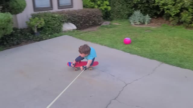 Father Helps Son Skateboard at Home During Quarantine