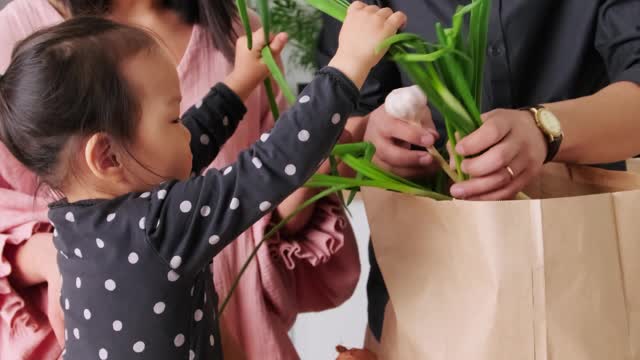 family-holding-green-onions