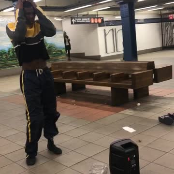 Guy does drag dance in subway station, wig flies off
