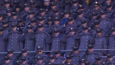 President Donald J. Trump salutes as the National Anthem is performed at the Army Navy game.