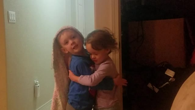 Boy and girl fraternal Twins give eachother a hug while playing Repunzel