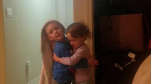 Boy and girl fraternal Twins give eachother a hug while playing Repunzel