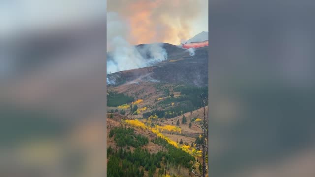 Moment Very Large Tanker Aeroplane Drops Load On Wildfire