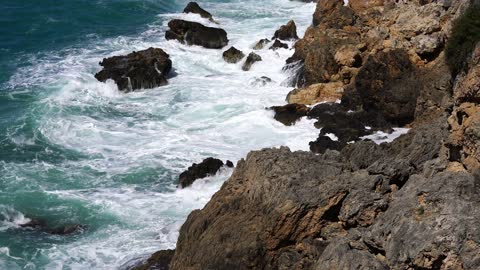 Waves at foot of a mountain FHD