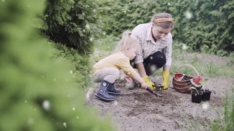 Cute Baby Enjoying And Helping Her Mother In Garden
