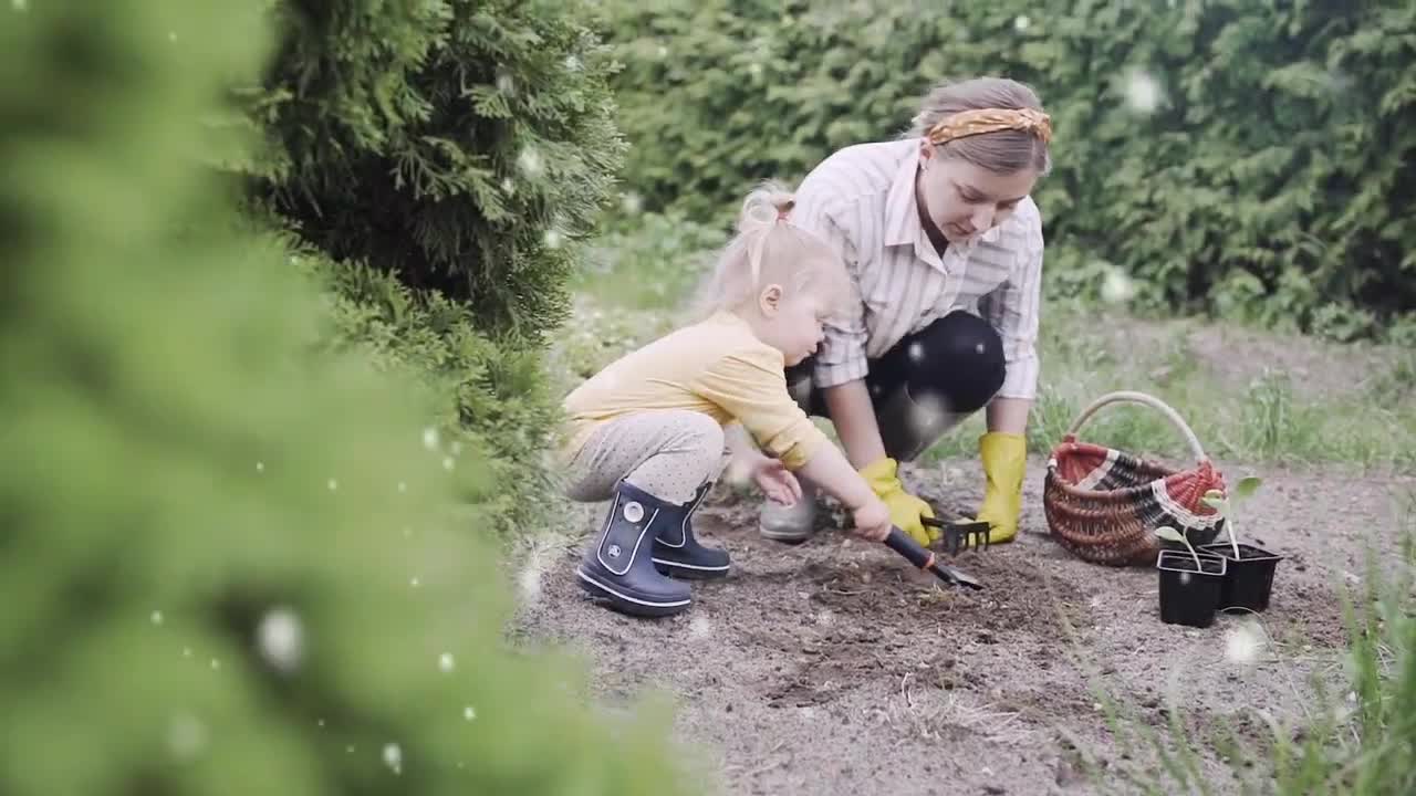 Cute Baby Enjoying And Helping Her Mother In Garden