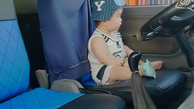 Cute baby as truck driver