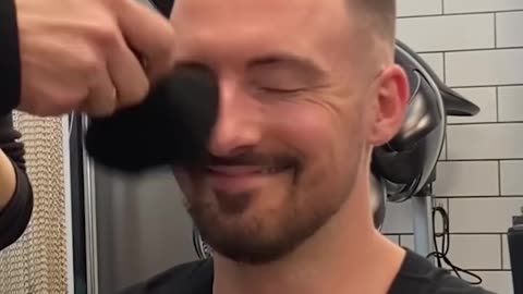 Hairdresser keeps brushing customer's face