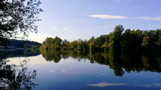 Distorted Reflection Of The Surrounding Lake On Its Water Surface