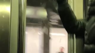 Guy leaves burn marks on subway train ceiling using a lighter