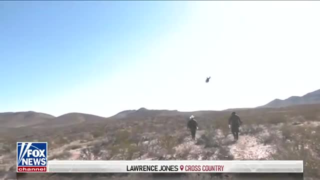 Lawrence Jones speaks with migrants at southern border