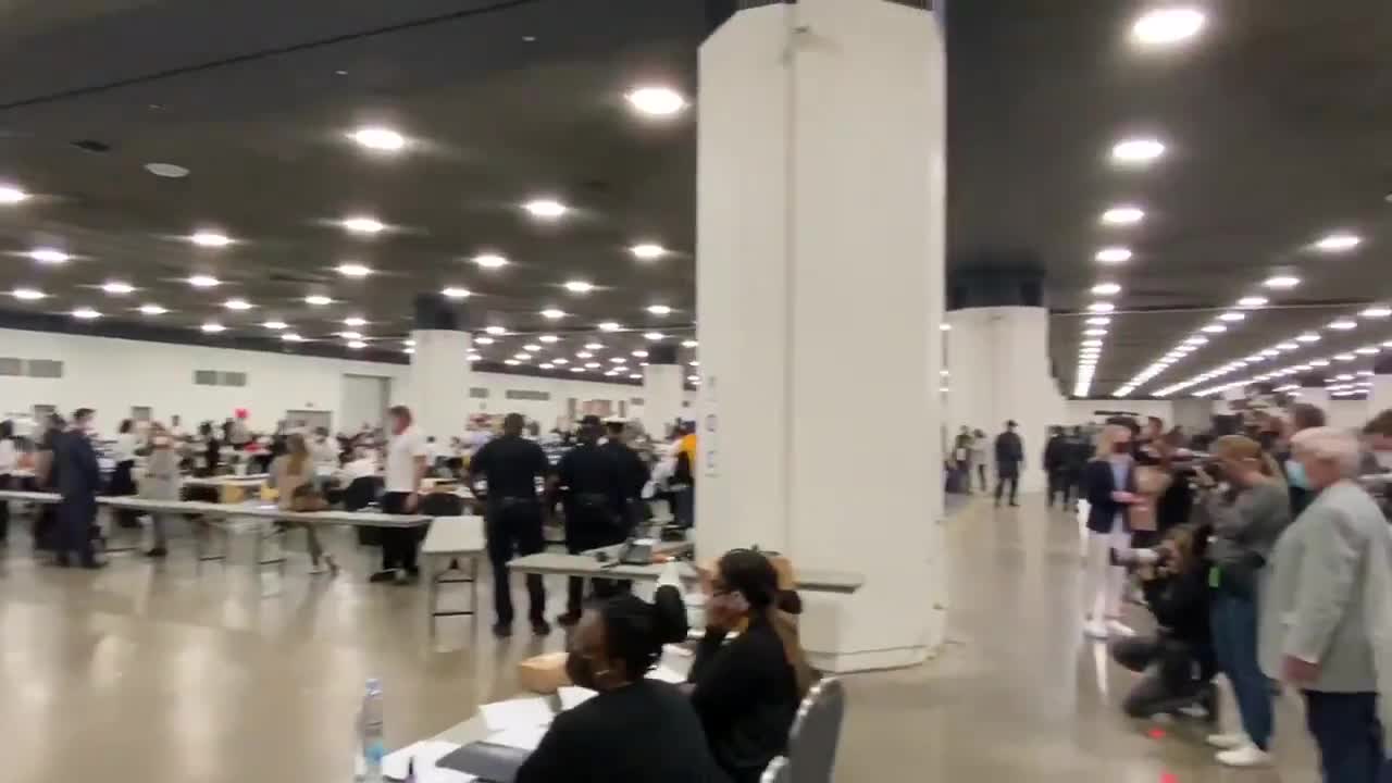 Man in Detroit boarding up windows of poll center 2020 election