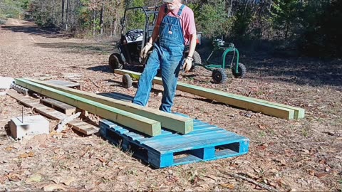 Deer blind: Moving stilts to build site.