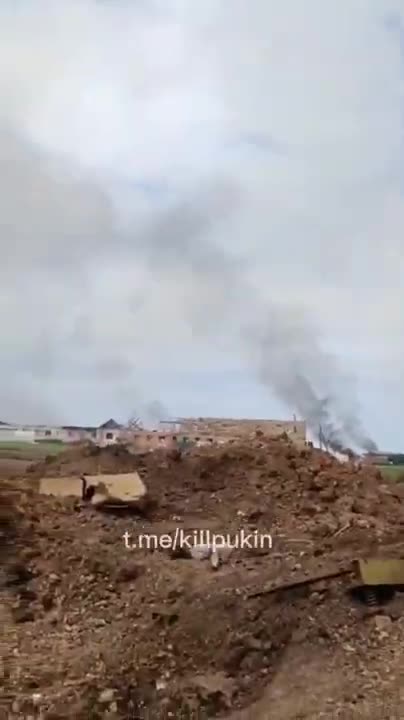A Russian soldier films from a trench under artillery fire in Kharkiv region ukrain