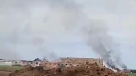 A Russian soldier films from a trench under artillery fire in Kharkiv region ukrain