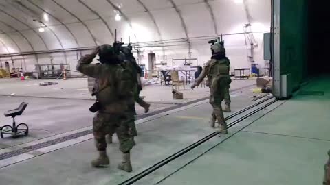 Taliban fighters inspect Chinook helicopters at Kabul airport after the U.S. leaves