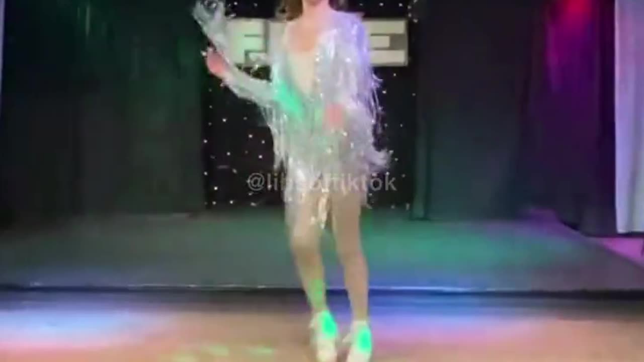 Teen drag queen who identifies as trans performing in a nightclub.