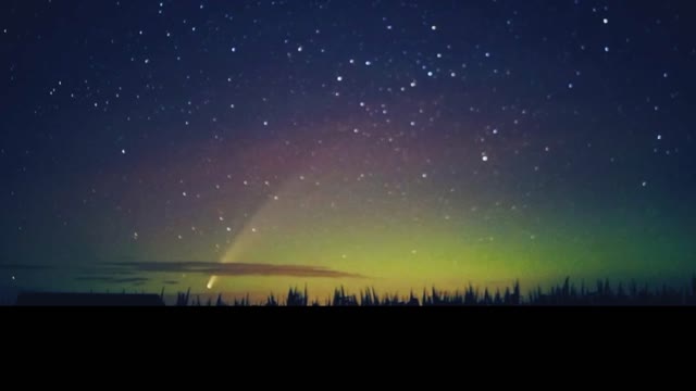 Comet Drifts Though Northern Lights