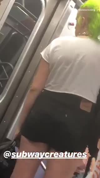 Person with green hair small black shorts