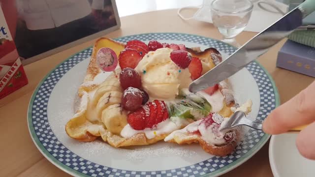 A bite of toast with fresh fruit