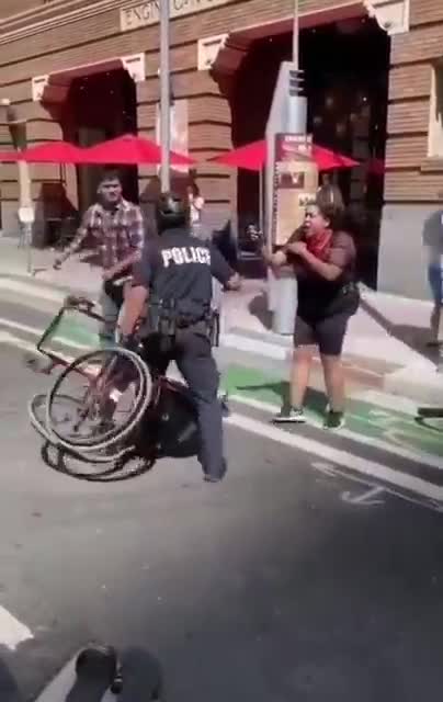 Australian police beating up a crippled black covid tyranny protester.