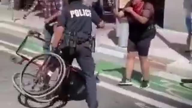 Australian police beating up a crippled black covid tyranny protester.