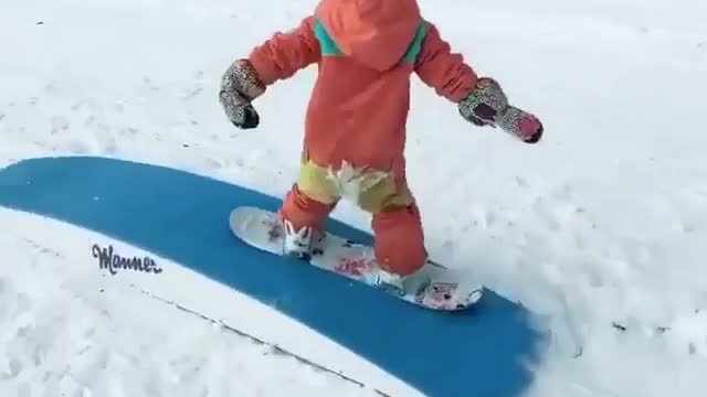 At only 4 years old, Emma is a talented snowboarder. 🏂