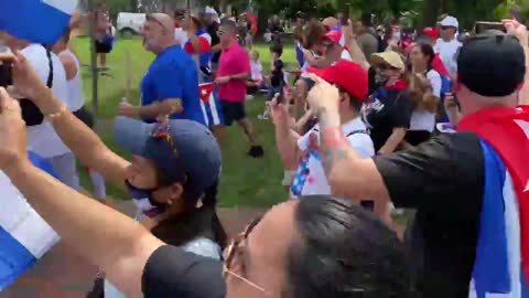 Cuban-American protesters chase away a reporter outside the White House.