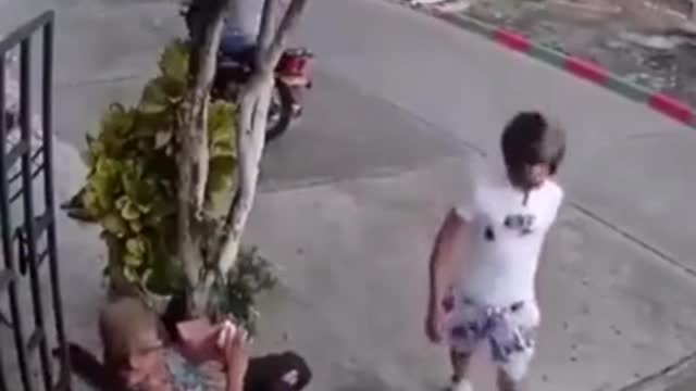 The man wants to steal the old woman's phone, but the old woman can handle it