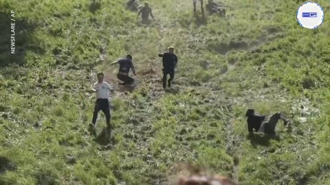 People, cheese roll downhill, wipeout in quirky annual competition