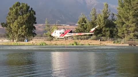 Helicopters picking up water at the dip site