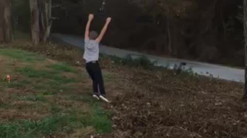 Boy spins over road on wire