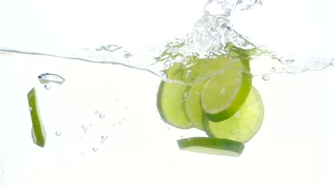 Lime slices falling through water