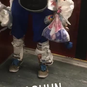 Man wears plastic bags as clothes