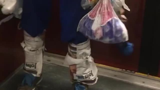 Man wears plastic bags as clothes