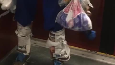 Man wears plastic bags as clothes